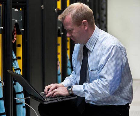 Man Kneeling With Laptop