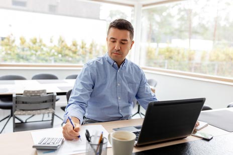 Man Writing Note At Laptop Sunny