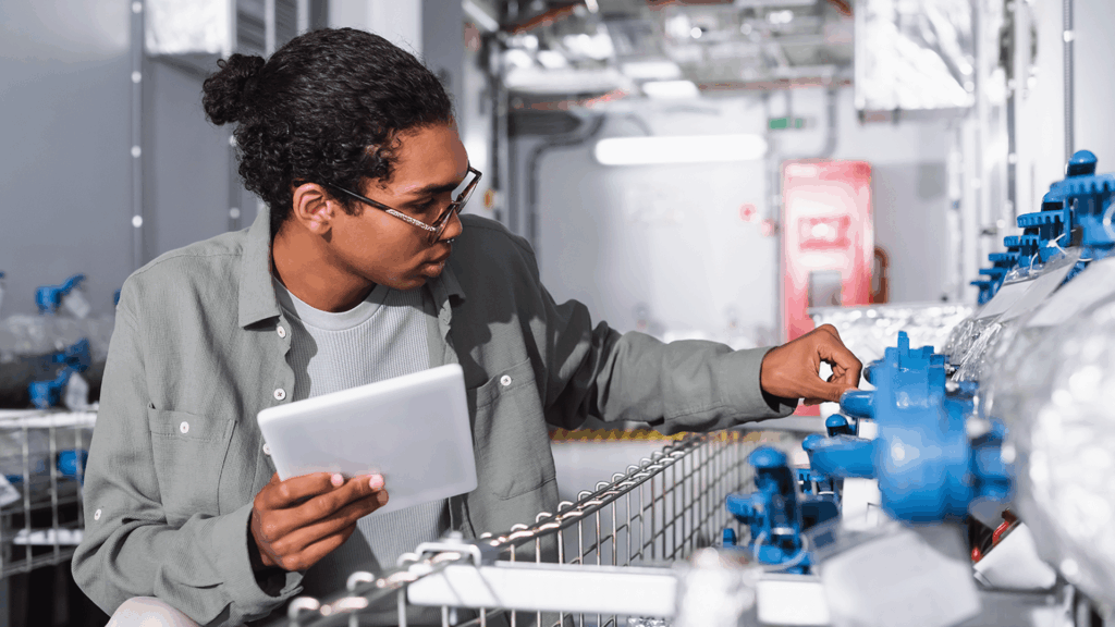 engineer with a tablet checking a data center’s cooling system